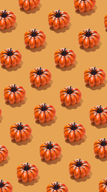 istock Vertical banner with pumpkin pattern on orange background. Minimal autumn, Halloween concept 2181738926