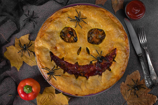 istock Halloween homemade vegetables pie with scary face. Autumn theme 2181739587