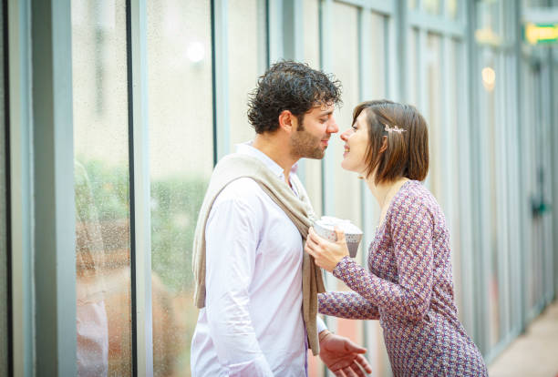 istock Romantic couple exchanging gifts on a rainy day 2181742032