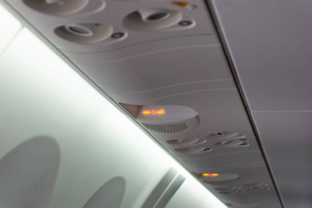 istock Overhead Compartment with Emergency Exit Indicators and Lighting in the Interior of a Commercial Passenger Aircraft Cabin. 2181742039