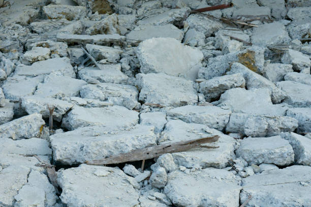 Weathered,jagged rocks covered in ice and snow in a harsh,desolate wilderness landscape. This bleak,inhospitable environment shows the powerful effects of extreme cold,wind.