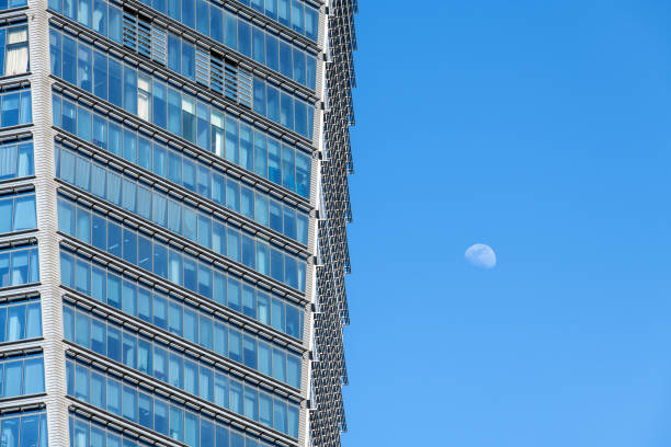 white moon and skyscraper in the blue sky