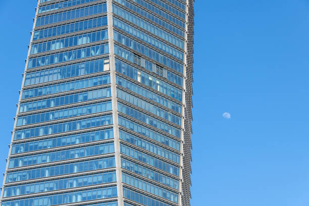 istock white moon and skyscraper in the blue sky 2181743482