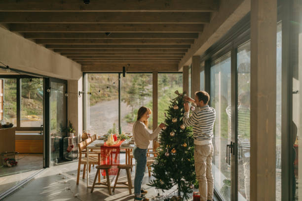 istock Couple is decorating a Christmas tree 2181745438