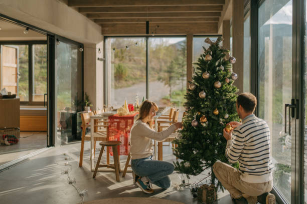 istock Couple is decorating a Christmas tree 2181745440