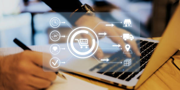 istock Digital shopping interface with icons and laptop in a workspace environment. 2181745785