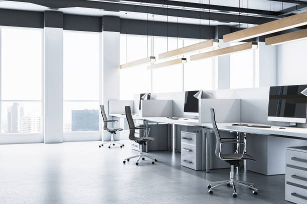 istock Modern office interior with desks, computers, and city view through large windows. 3D Rendering 2181746002