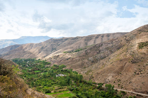 istock Serene valley landscape with lush greenery nestled between hills 2181746117