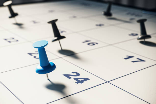 Close-up of a calendar with pushpins marking specific dates. 3D Rendering