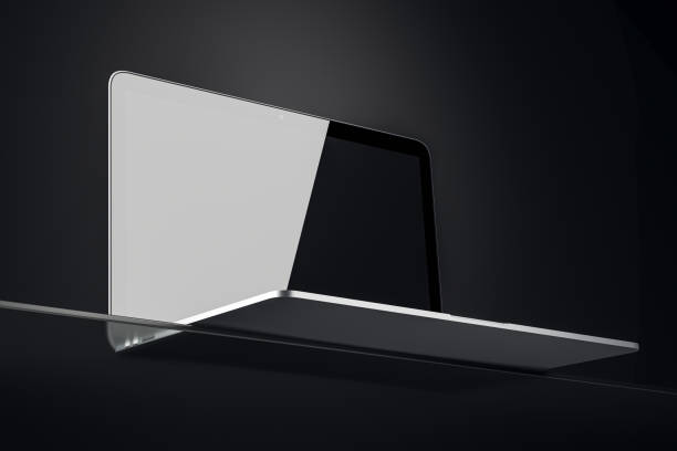 Open laptop with a blank screen on a glass stand, viewed from a low angle in a dark room. Clean and modern design template. 3D Rendering