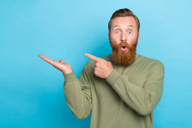istock Portrait of excited impressed guy wear khaki pullover palm showing object indicating empty space isolated on turquoise color background 2181747845