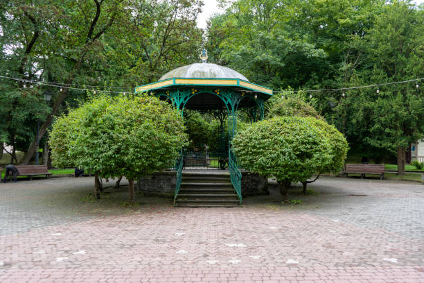 istock Gazebo on the street. Green trees rest zone 2181749484