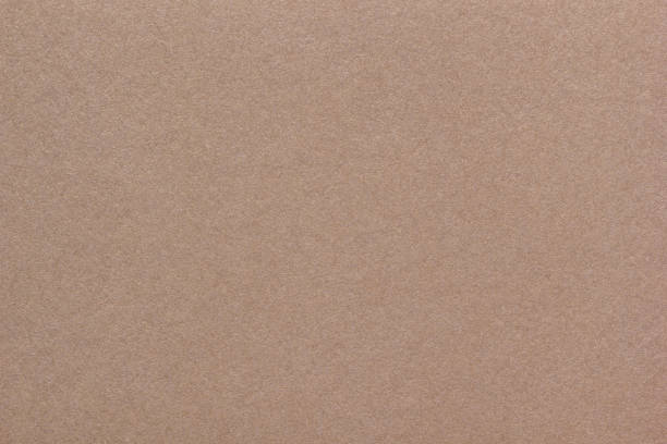 istock Textured glossy brown paperboard background. Horizontal scabrous cardboard background 2181749701