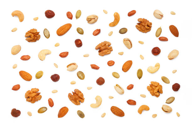istock Background from different types of nuts and seeds. Isolated on white background 2181749921