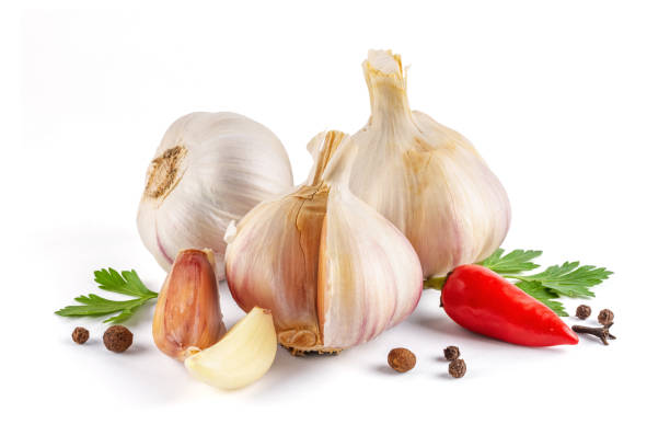 Garlic bulbs with chili pepper and parsley isolated on a white background close-up