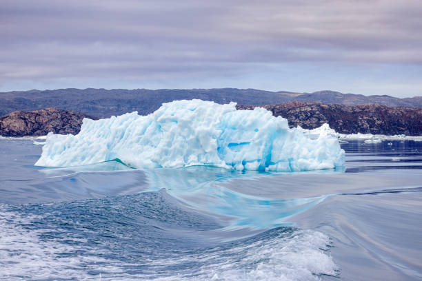 Detail of a patch of Antarctic sea ice, containing wonderous shapes and deep blue colours.