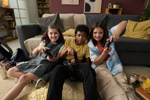 istock Children Playing Video Games with Controllers in Hands 2181750813