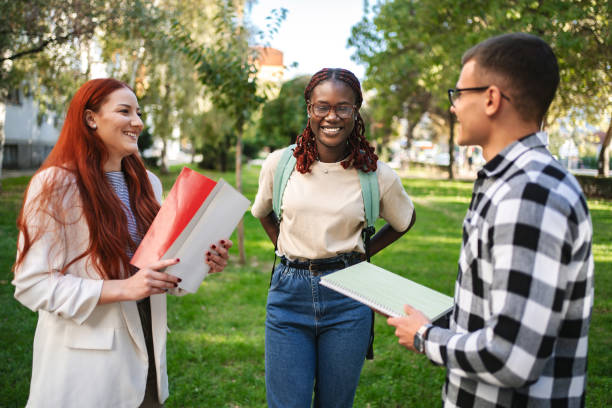istock Students engage in lively discussion outdoors while preparing for their upcoming project in a university park on a sunny afternoon 2181751077