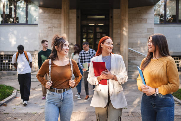 istock Students engage in lively discussion outside their campus building on a sunny day, showcasing friendship and academic enthusiasm 2181752235