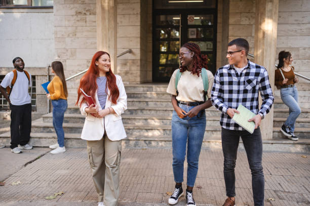 istock Students engaging in lively conversation together on the university campus steps during a sunny afternoon 2181752516