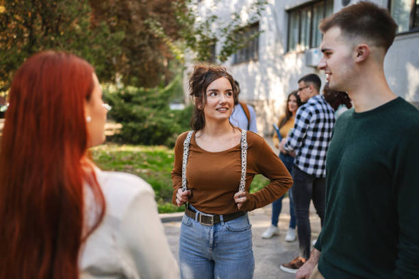 istock Students engaged in lively conversation outdoors on a sunny day, sharing ideas and laughter near their university campus 2181753245
