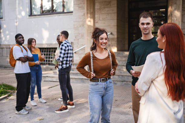 istock Students engage in lively conversations outside their university building on a sunny afternoon, exchanging ideas and laughter 2181754068