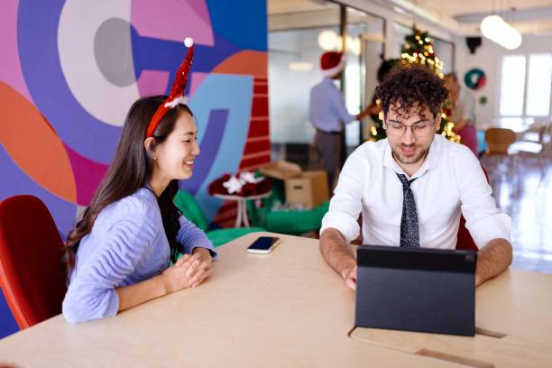 istock Smiling colleagues talking about their plans for Christmas 2181754236