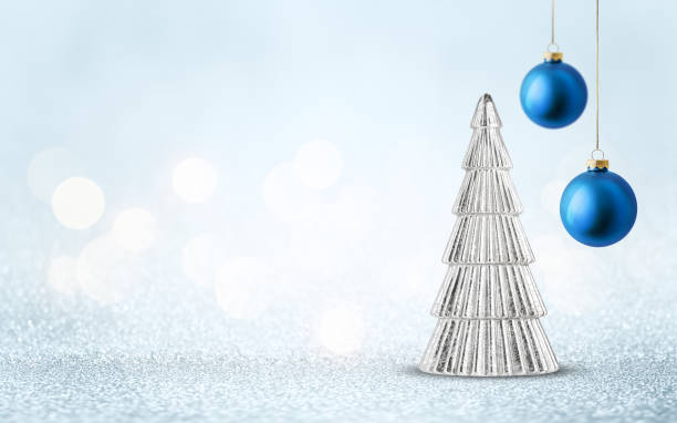 istock Christmas tree decoration with blue bauble on silver shiny glitter background with bokeh light. Festive winter holiday decor and ornament. 2181754422