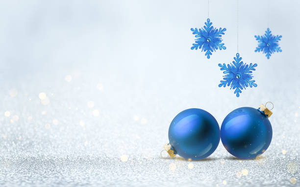 istock Blue bauble and hanging snowflake decoration on silver shiny glitter background with bokeh light. Festive winter holiday decor and ornament. 2181754432