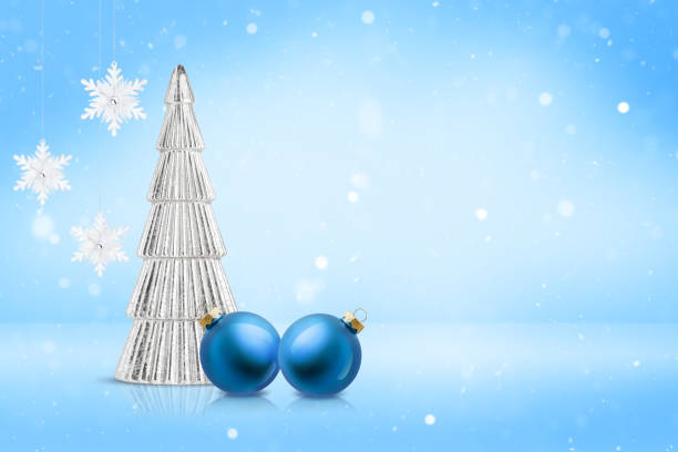 istock Silver Christmas tree decoration, hanging snowflake and bauble ornament on light blue snowy background. Festive winter holiday backdrop with copy space. 2181754460