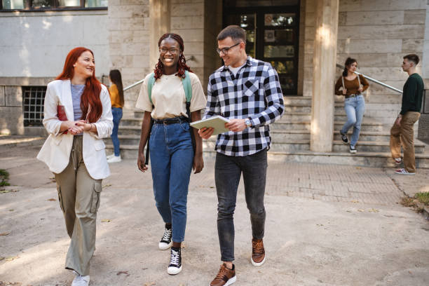 istock Students engaging joyfully outside their university buildings, sharing ideas and laughter during a sunny afternoon 2181754484