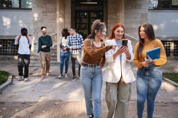istock Students engage in a lively discussion while walking on campus, sharing highlights of their college experience on a sunny afternoon 2181754620