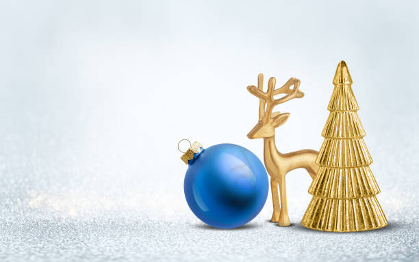 istock Christmas tree decoration, blue bauble and gold deer figurine on silver shiny glitter background. Festive winter holiday decor and ornament. 2181754757