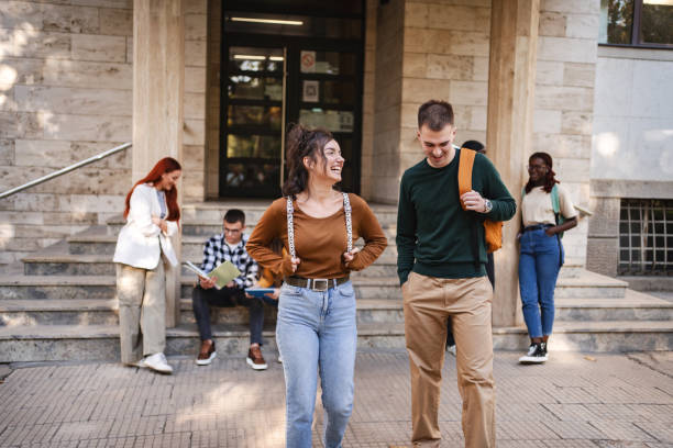 istock Students enjoying a sunny afternoon outside their university, engaging in lively conversation and study on campus steps 2181754800