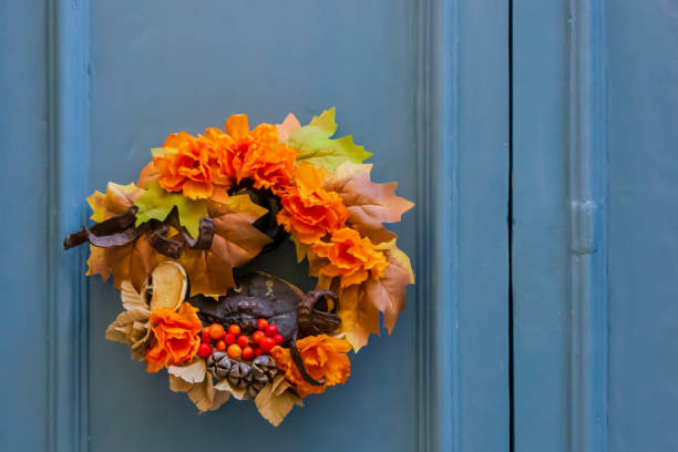 Wreath of autumn leaves hanging on a white door