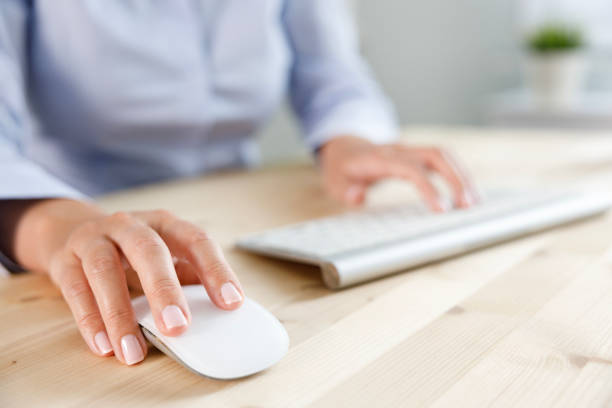 istock Close-up of business woman's hands with computer mouse 2181759168