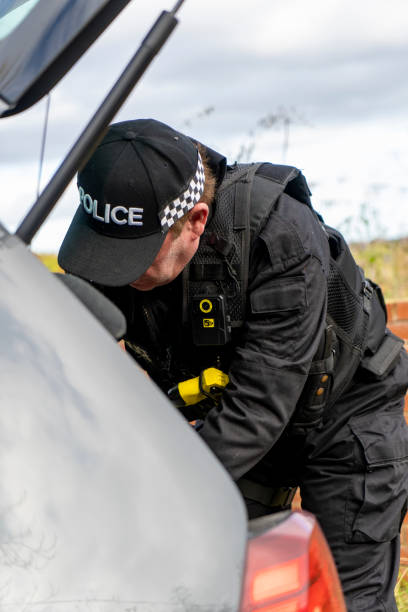 istock Armed UK police officer wearing baseball cap 2181763440
