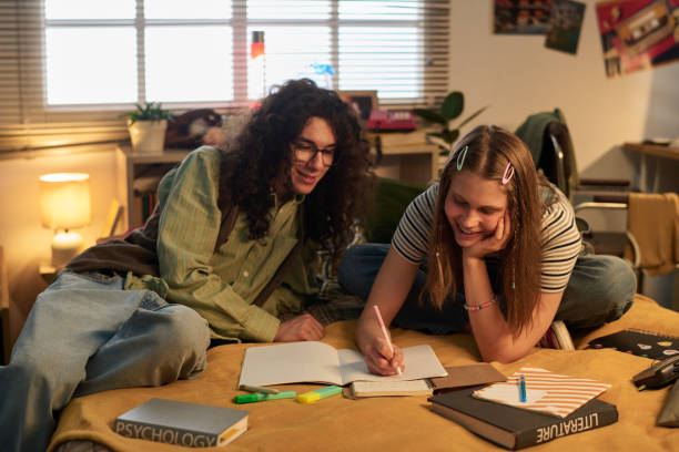 istock Smiling Students Collaborating on Homework in Cozy Room 2181766886