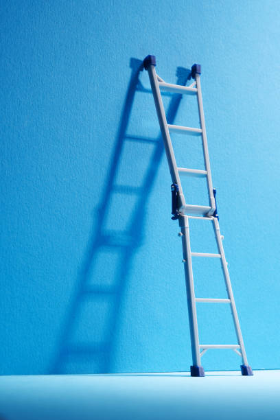 Blue wall with  small toy  folding ladder