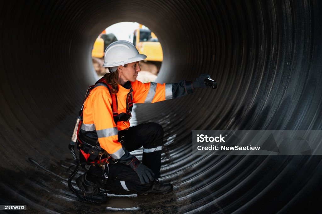 Engineer Inside Engineers Working Inside A Large Steel Pipe Worker Constructing A ...
