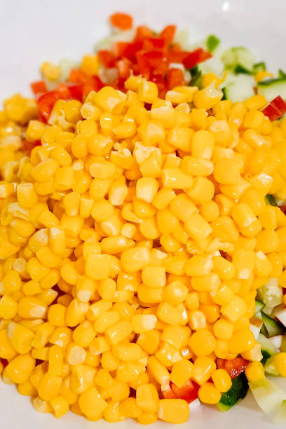 istock Yellow canned corn and other salad vegetables lie on a plate. 2181770654