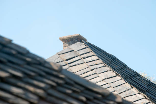 detail of grey slate shingles at a wall