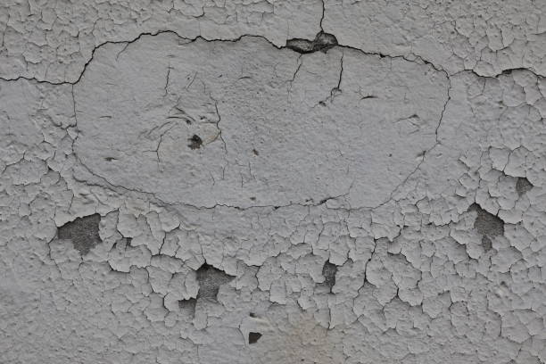 istock Close-up of cracked and peeling paint on concrete wall. 2181773280