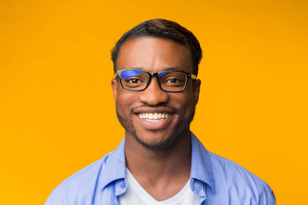 istock African American Man Smiling At Camera Posing Over Yellow Background 2181773715