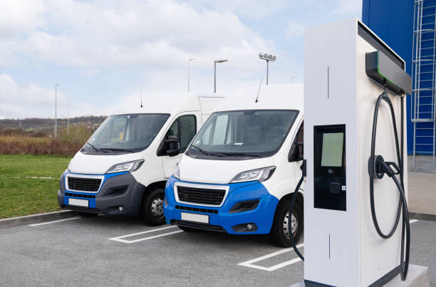 istock Electric delivery vans with electric vehicles charging station. 2181776331