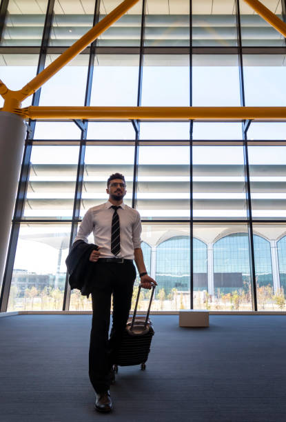 istock businessman pulling luggage in airport 2181776810