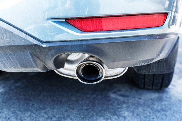 Rear view of an internal combustion engine car focusing on the aluminum exhaust pipe and muffler assembly.