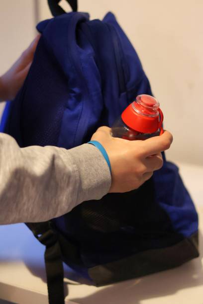 istock Preparation for school; packing an eco-friendly reusable filter bottle into a school backpack 2181777386
