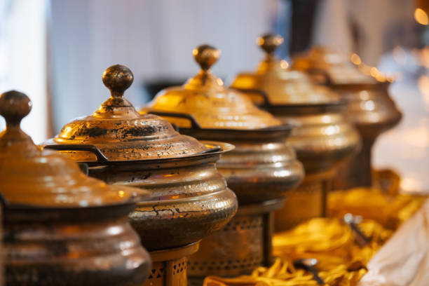 Catered food in decorative copper bowls with heaters underneath. Indian food. Buffet concept.