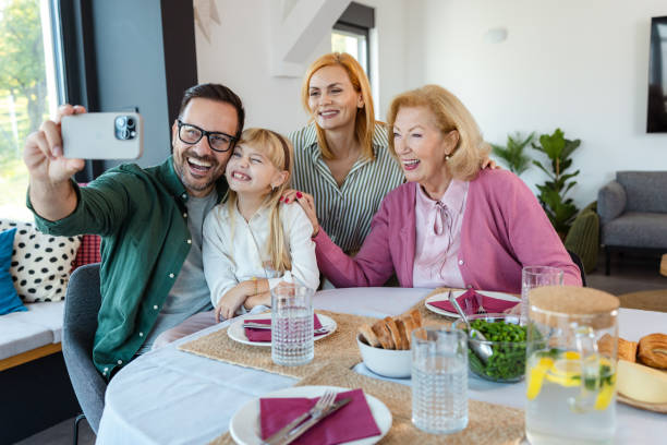 istock Multigenerational family enjoying a meal together while taking a selfie 2181780990